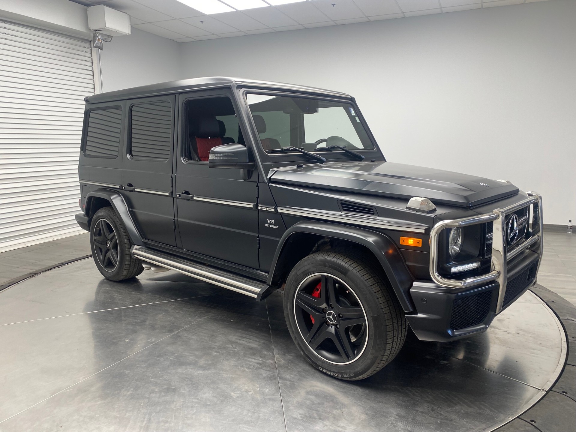 (SOLD) 2015 Mercedes-Benz G63 AMG G-Class (G-Wagon), DESIGNO MAGNO Night Black, DESIGNO Classic Red Leather, 5.5L Twin-Turbo V8 (536HP), Chrome Package, Harman Kardon Logic 7 Surround Sound, Heated Windshield, Ambiance Illumination, Canadian Vehicle Since New w/95,749km